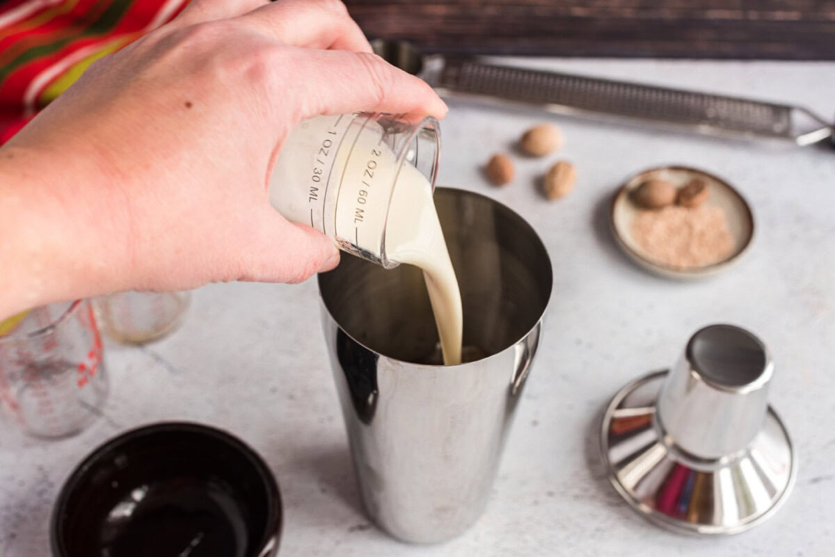 pouring cream into cocktail shaker