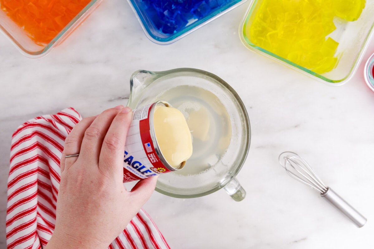 pouring sweetened condensed milk into gelatin