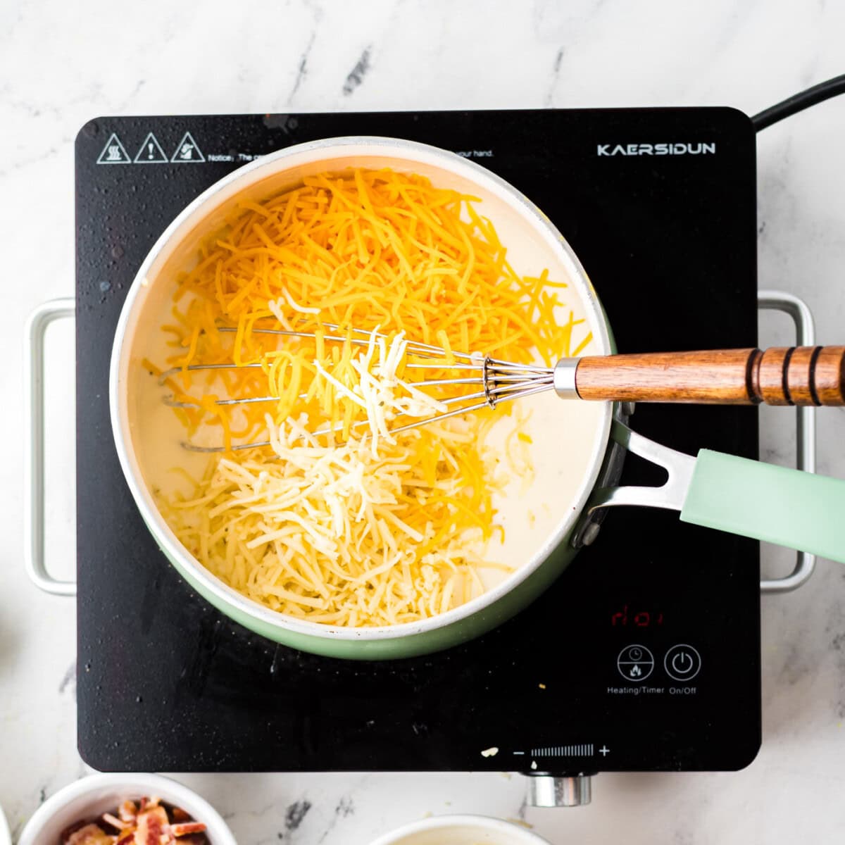 stirring cheese into sauce