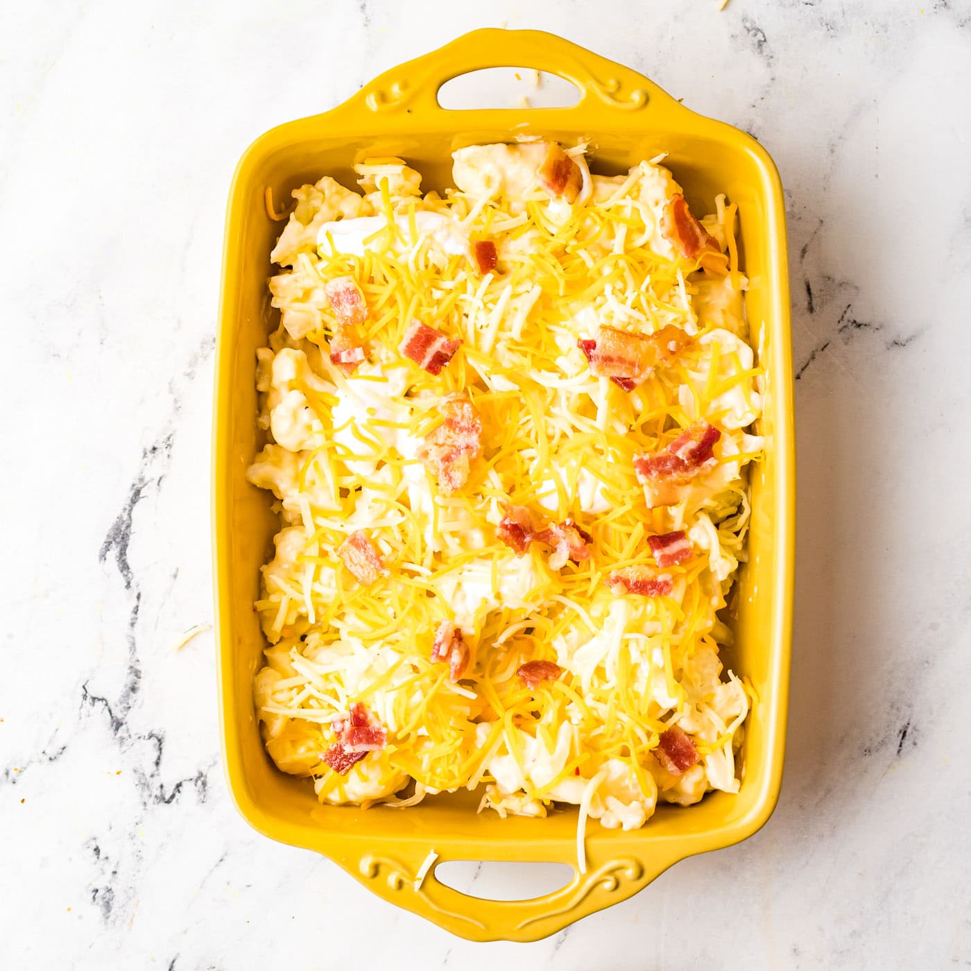 bacon and cheese on top of cauliflower casserole