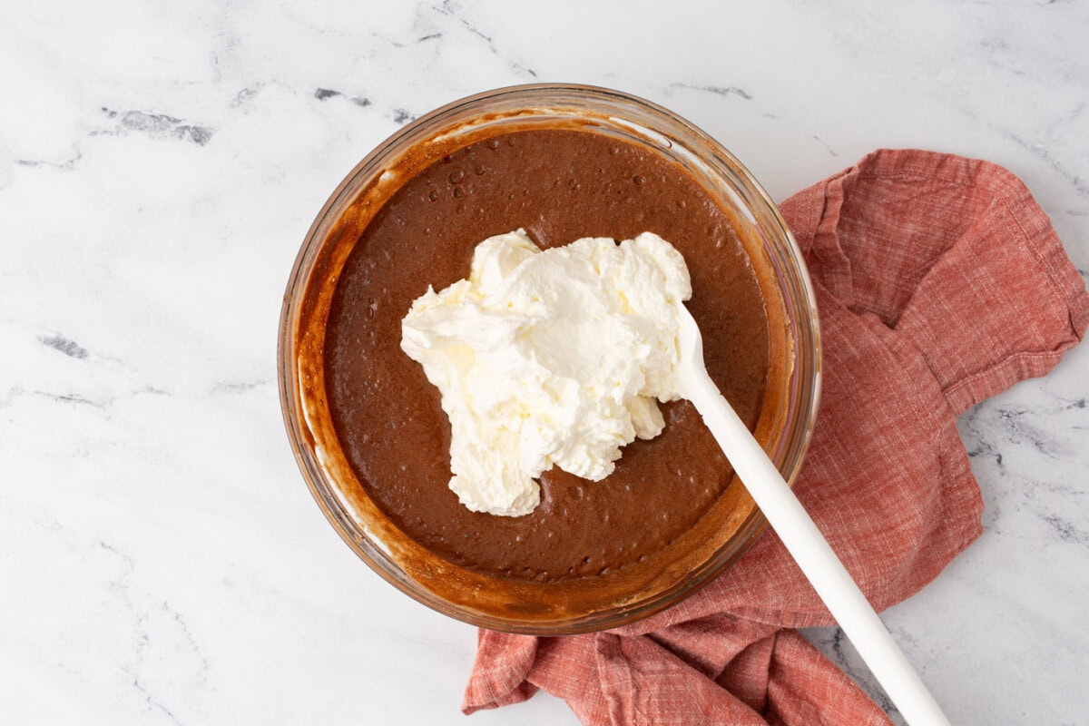 folding whipped cream into chocolate mousse