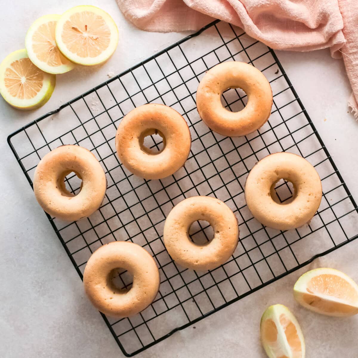 baked lemon donuts on a cooling rack