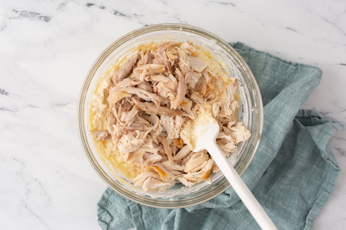 Stirring chicken into cream cheese mixture