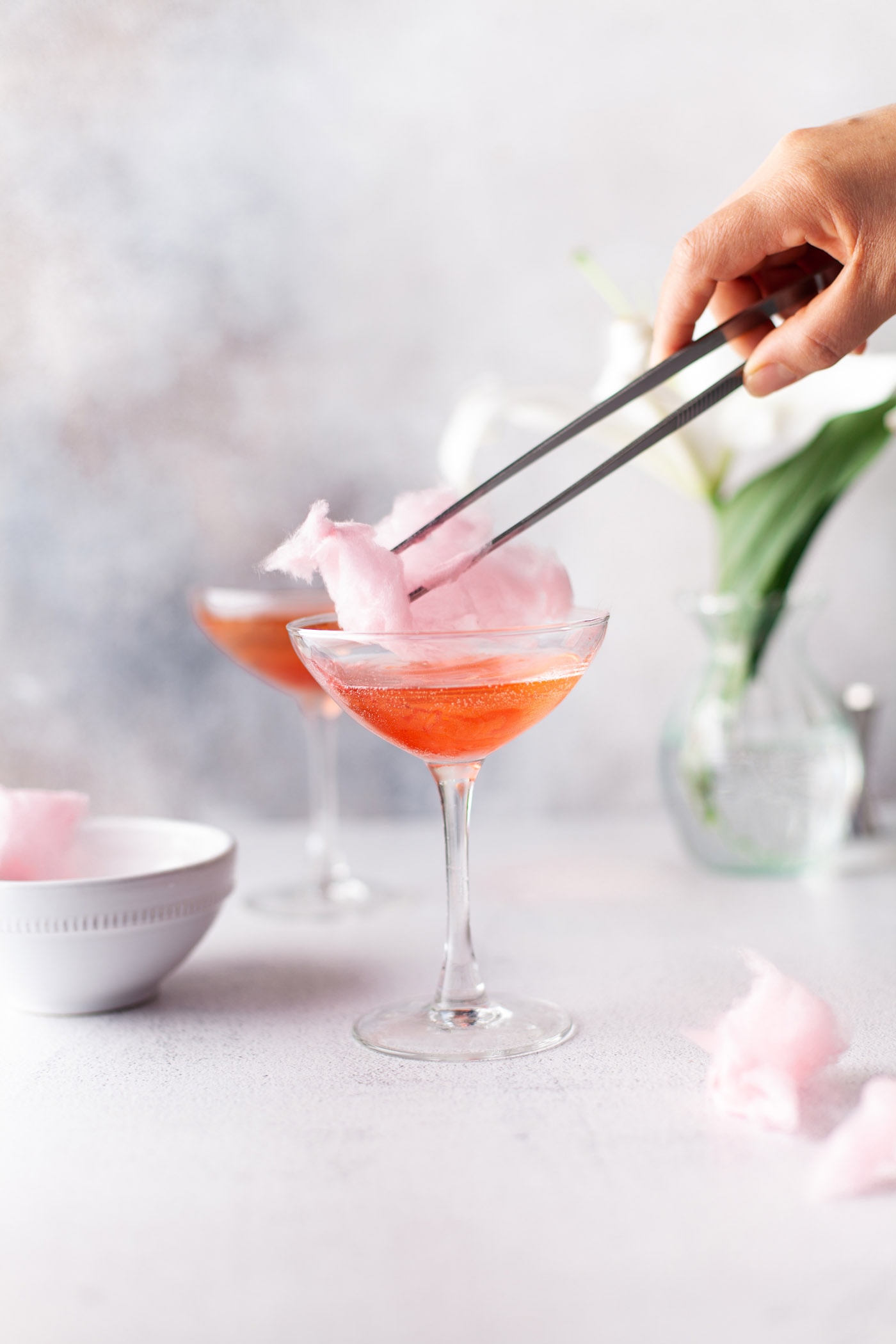 chopsticks adding cotton candy to the top of a glass