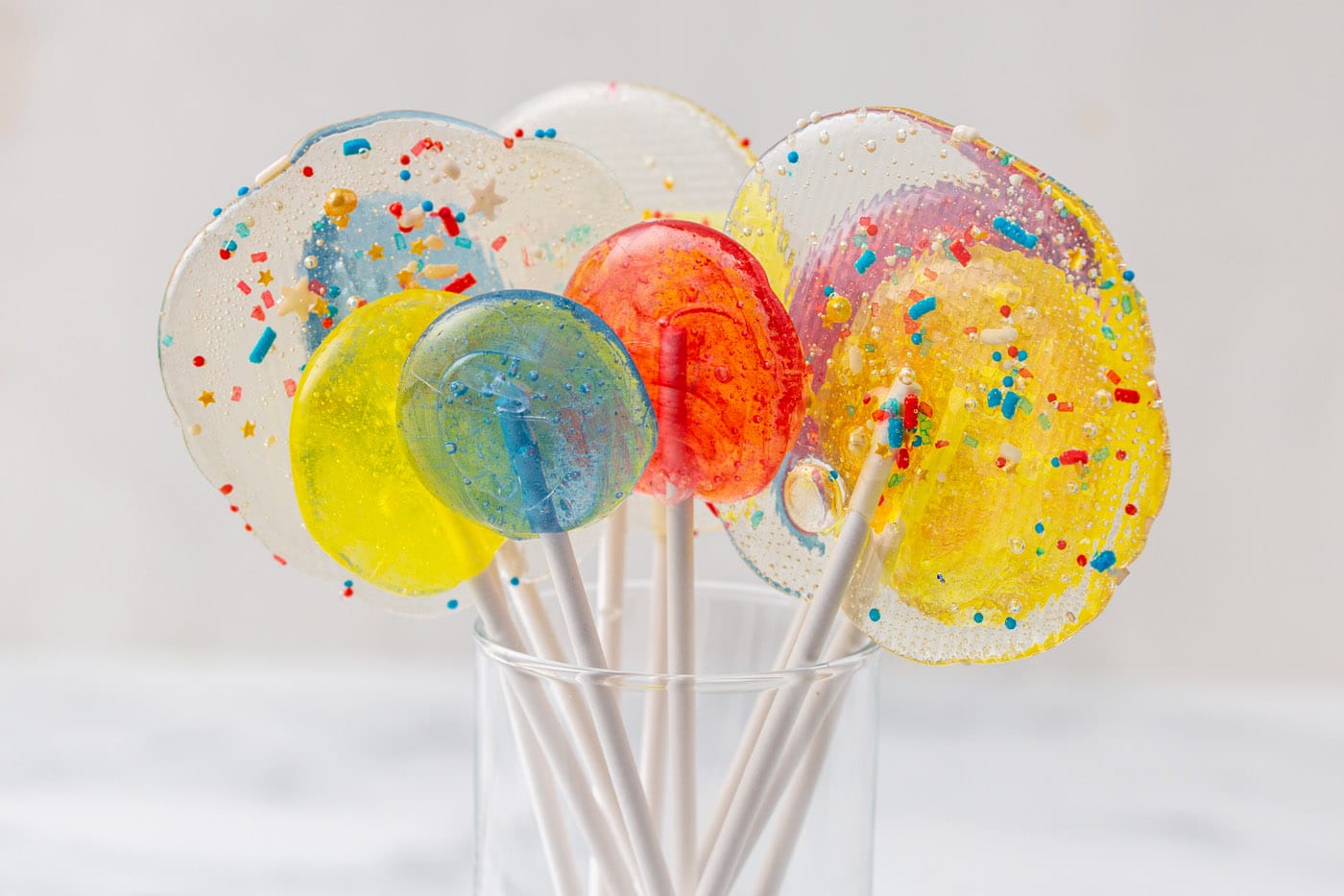 All you need to make homemade lollipops is light corn syrup, sugar, flavored extracts, optional food
