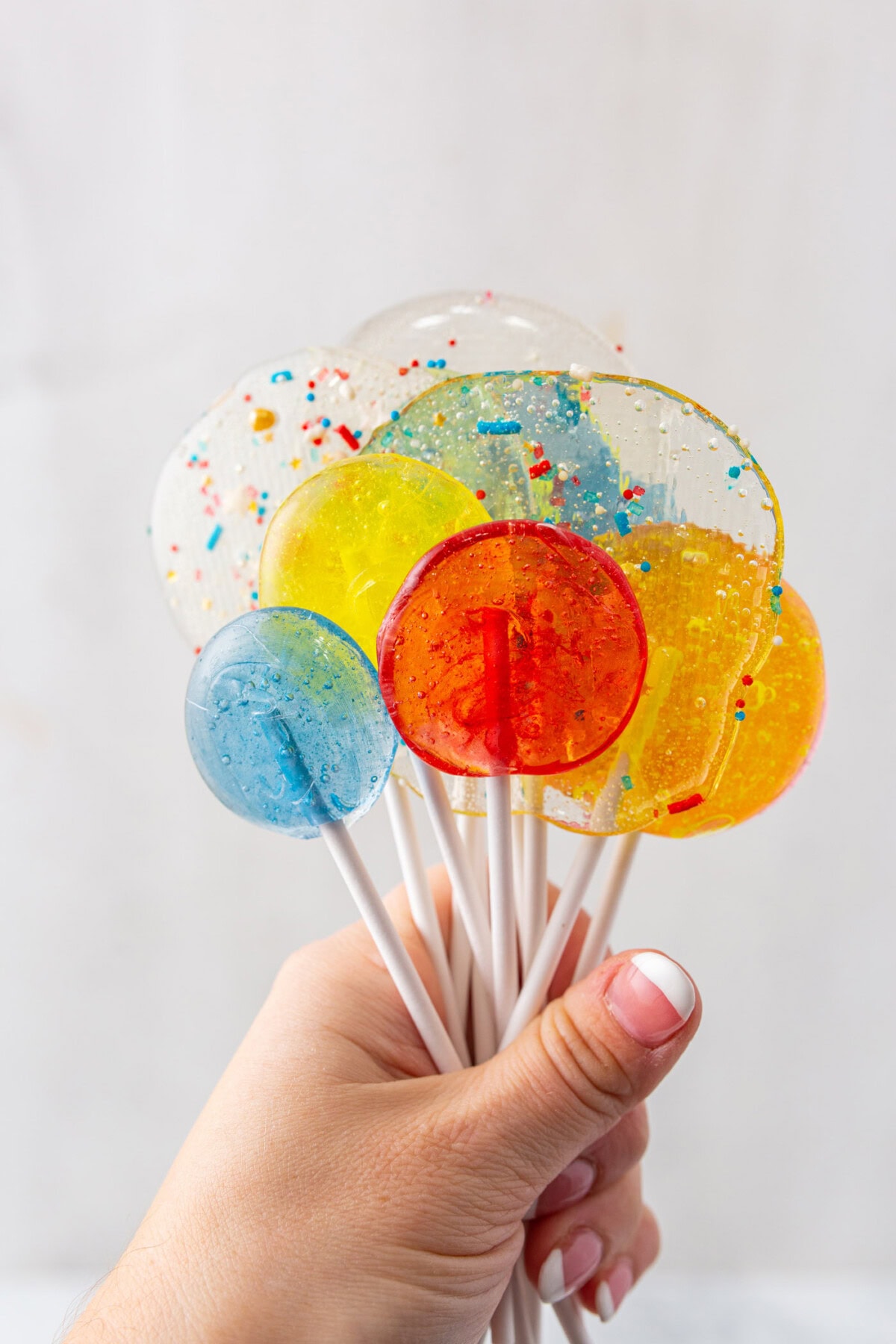 hand holding a bunch of Homemade Lollipops