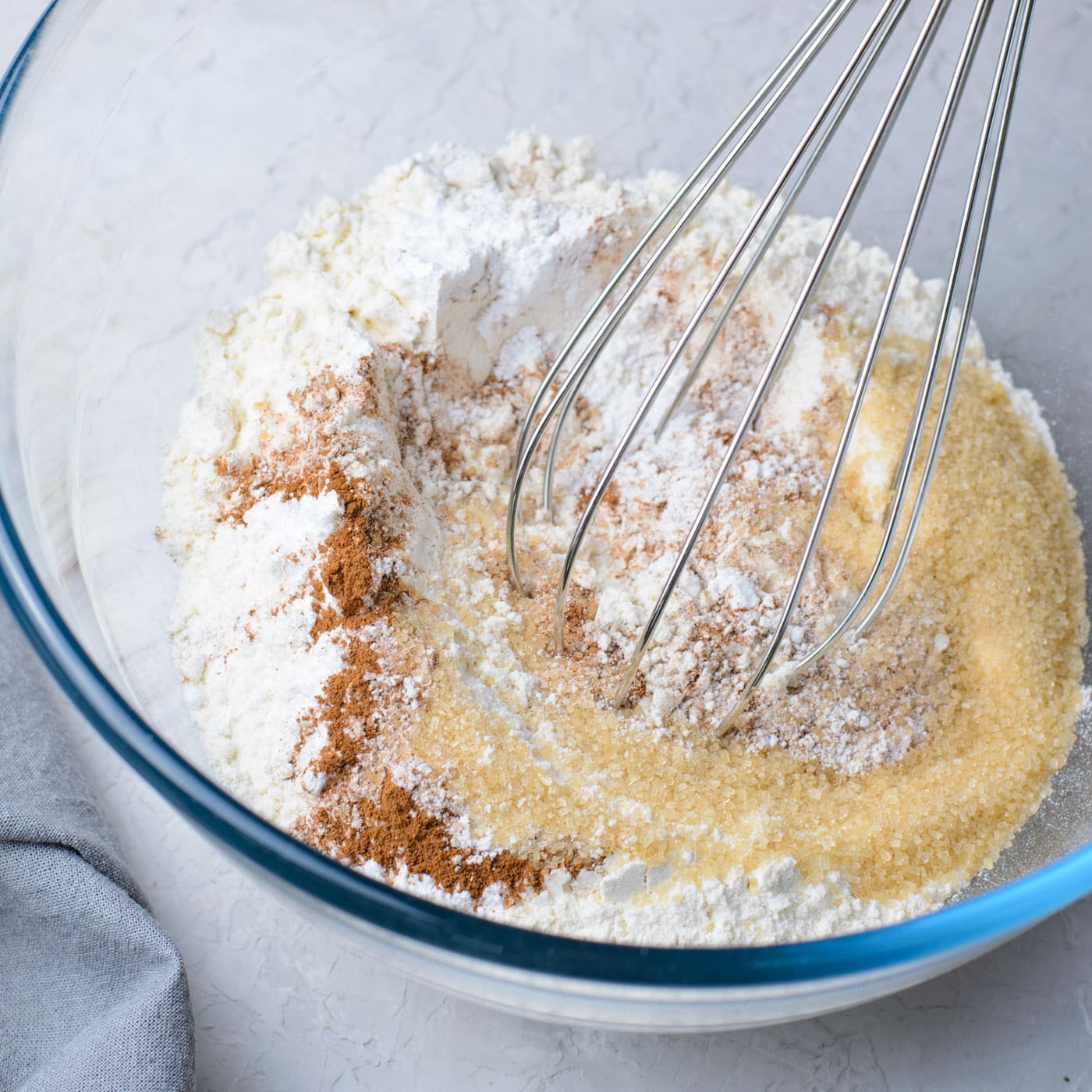 flour, baking powder, brown sugar, salt, and cinnamon mixed in a bowl