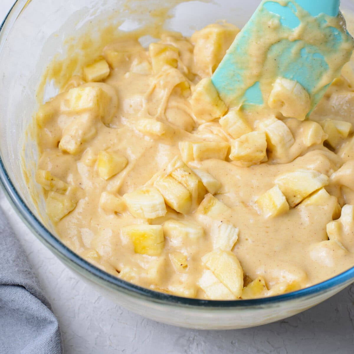 mixing chopped bananas into batter