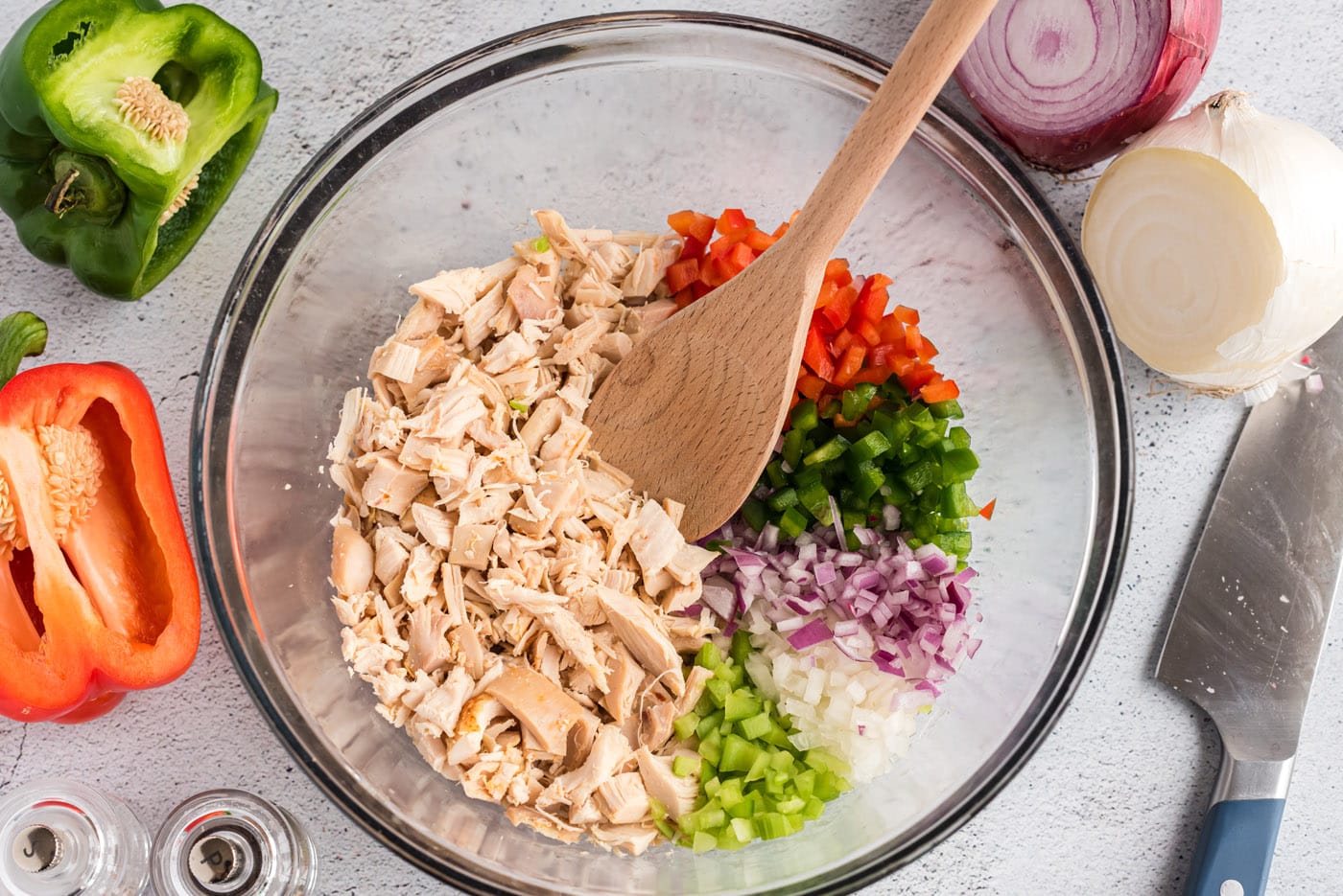 chicken, celery, green and red bell pepper, ,and onion in a mixing bowl