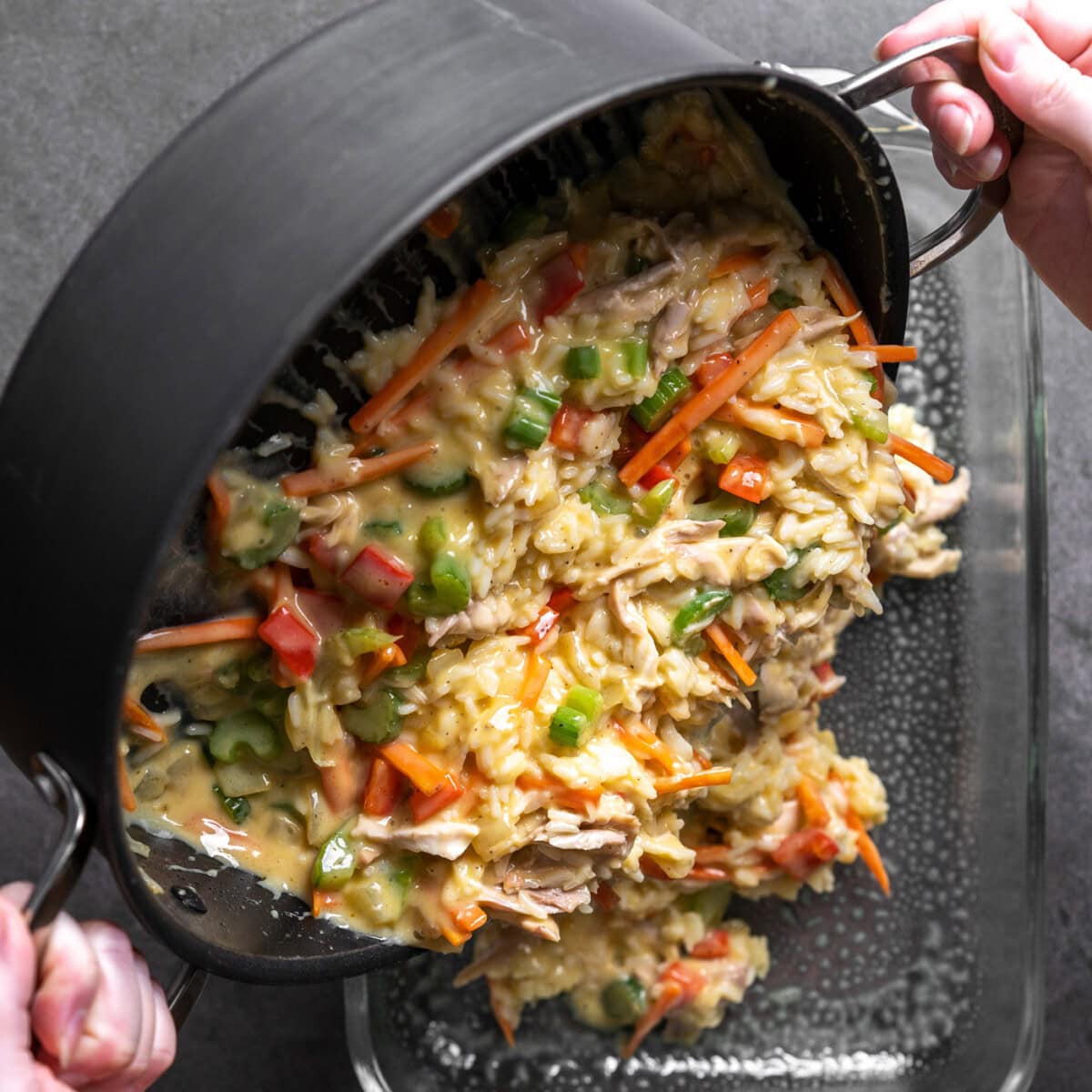 pouring chicken chow mein casserole ingredients into casserole dish