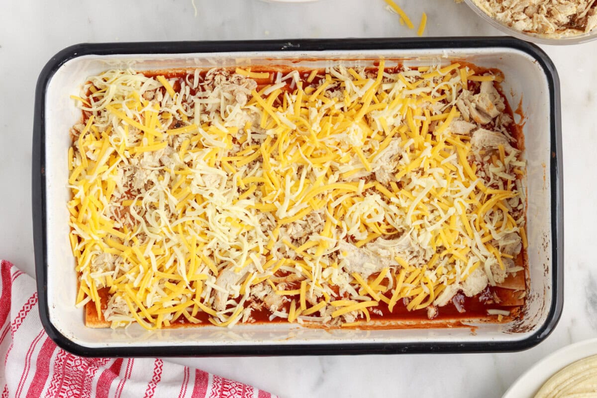 shredded cheese on top of chicken enchilada casserole