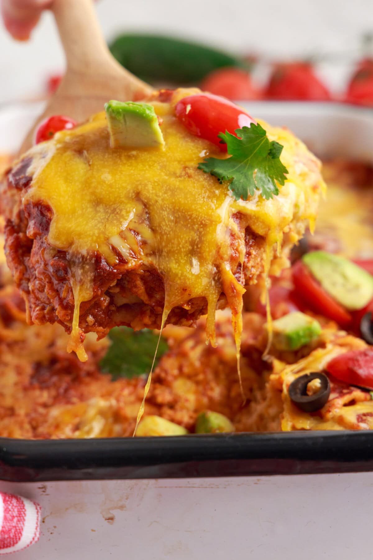 lifting a sptula serving of Chicken Enchilada Casserole
