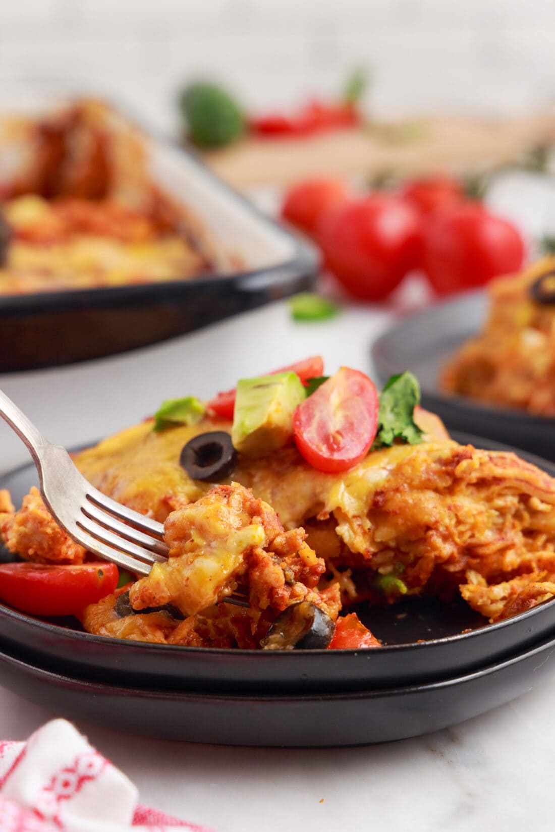 Chicken Enchilada Casserole on a plate with fork