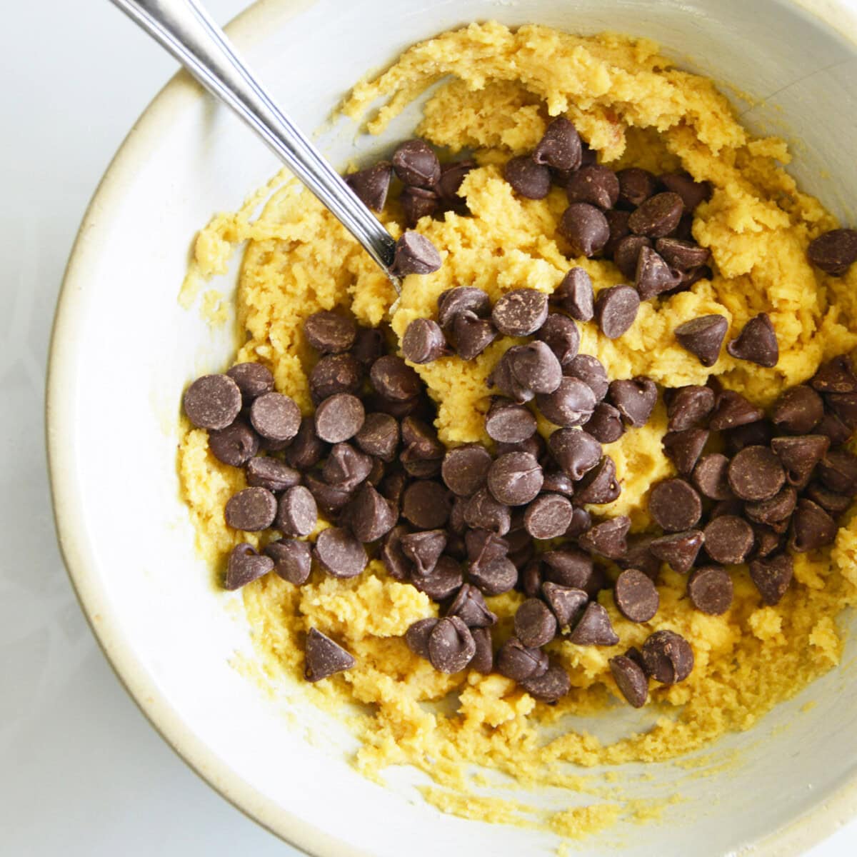 mixing chocolate chips into cookie dough