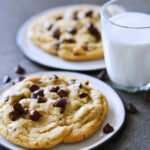 two chocolate chip cookies wit hmilk