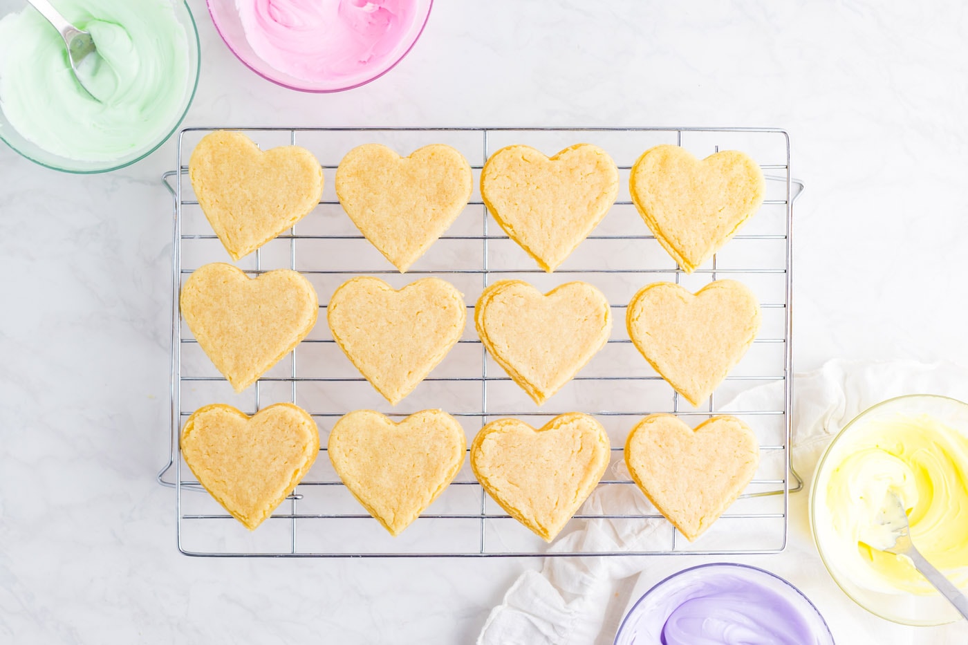 baked heart shaped sugar cookies on cooling rack