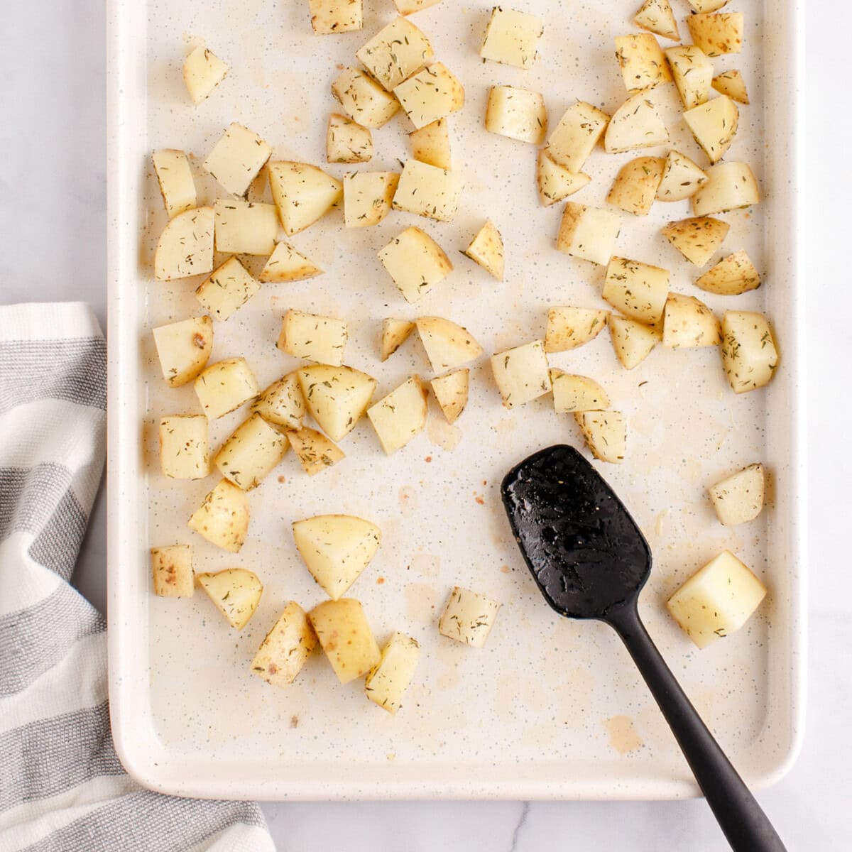 cubed potatoes on a baking sheet