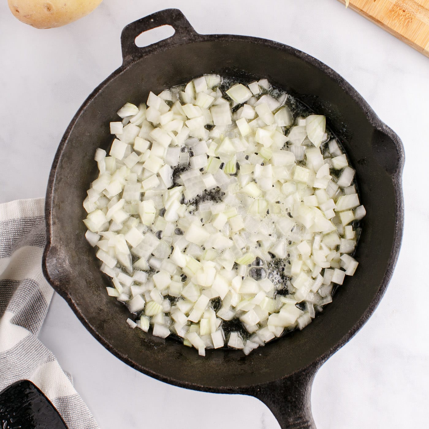 chopped onion frying in a skillet