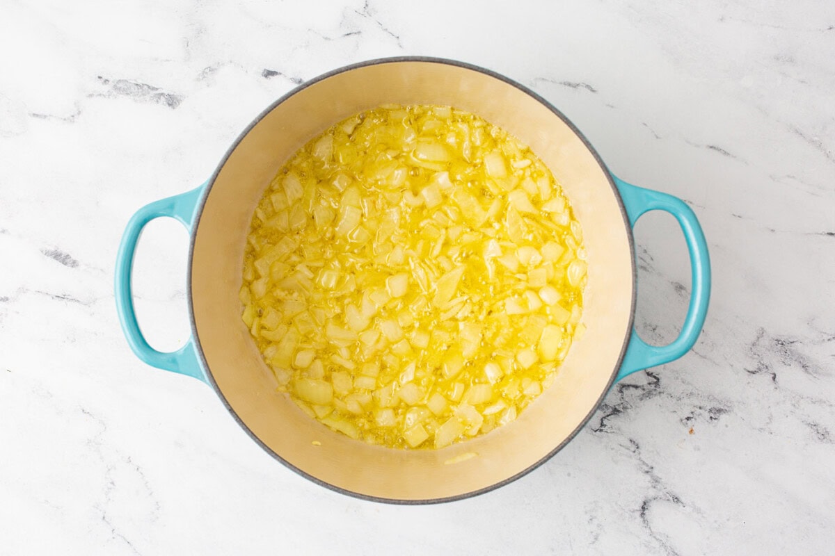 chopped onion with butter in a dutch oven