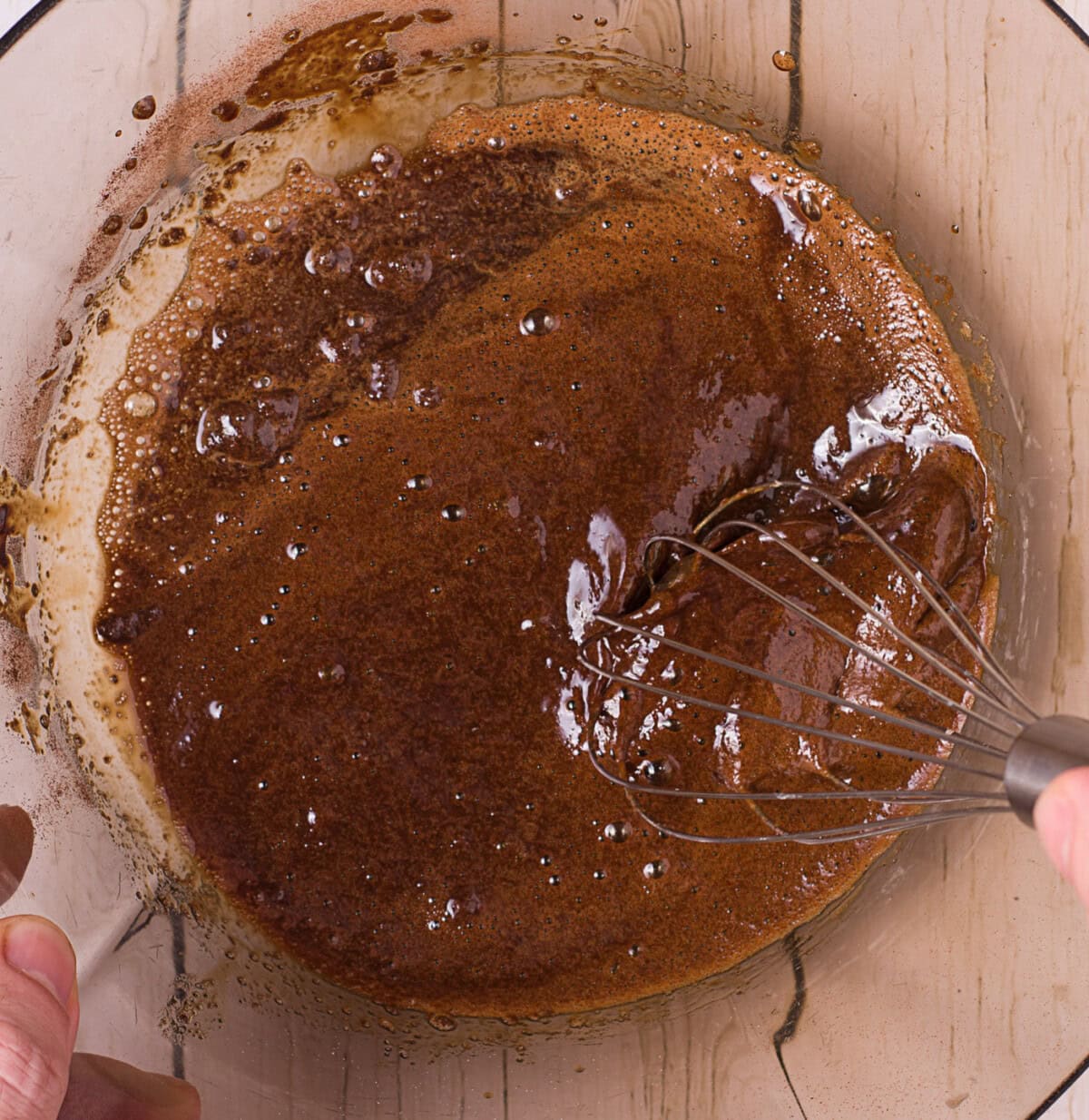 whisking instant coffee, water, and sugar in a bowl
