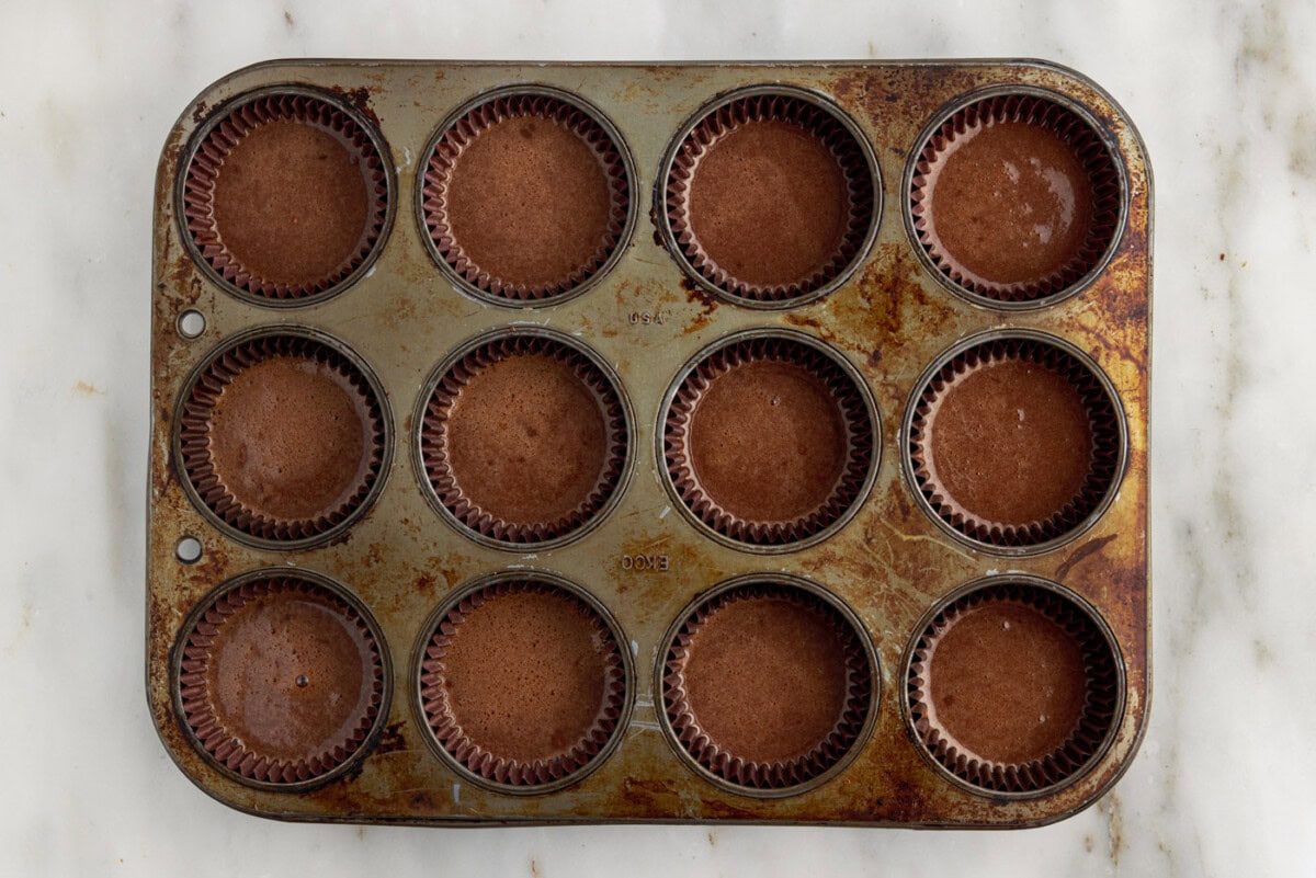 chocolate cupcake batter in a muffin tin