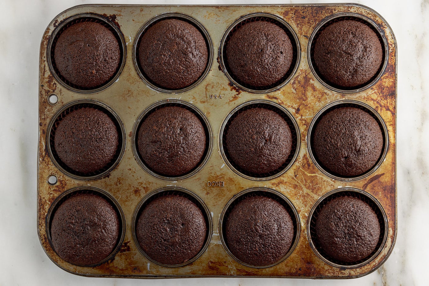 baked double chocolate cupcakes in a cupcake tin