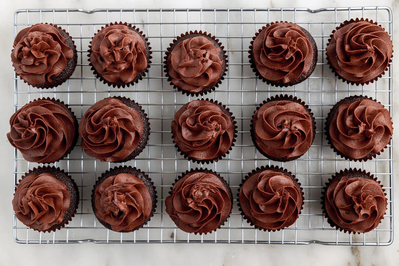 chocolate fudge frosting on top of chocolate cupcakes