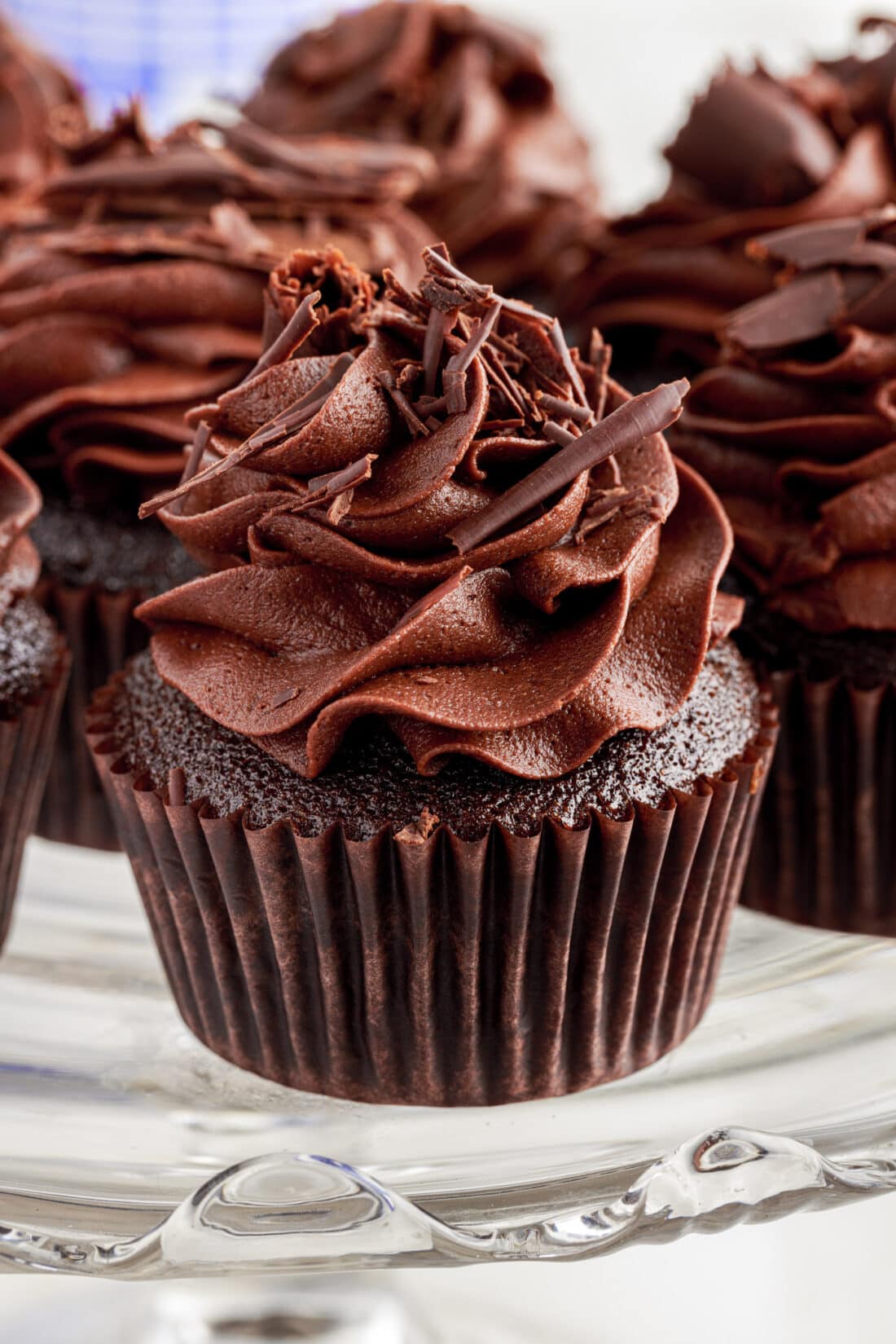 A close up of a Double Chocolate Cupcake on a cake stand