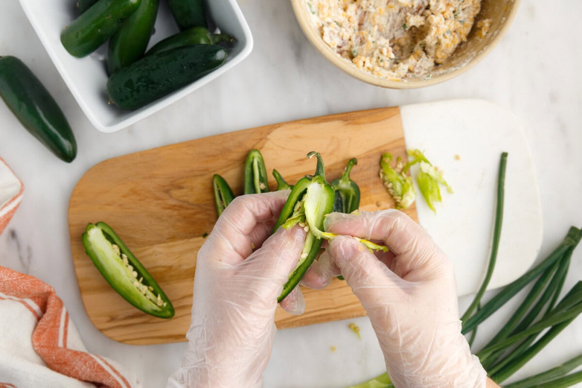 hands scooping jalapeno ribs