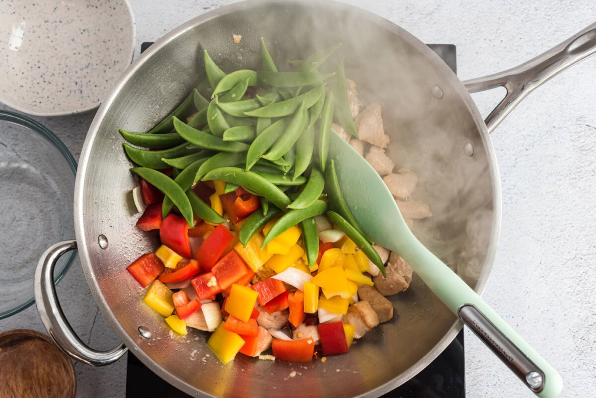 veggies with chicken in a wok
