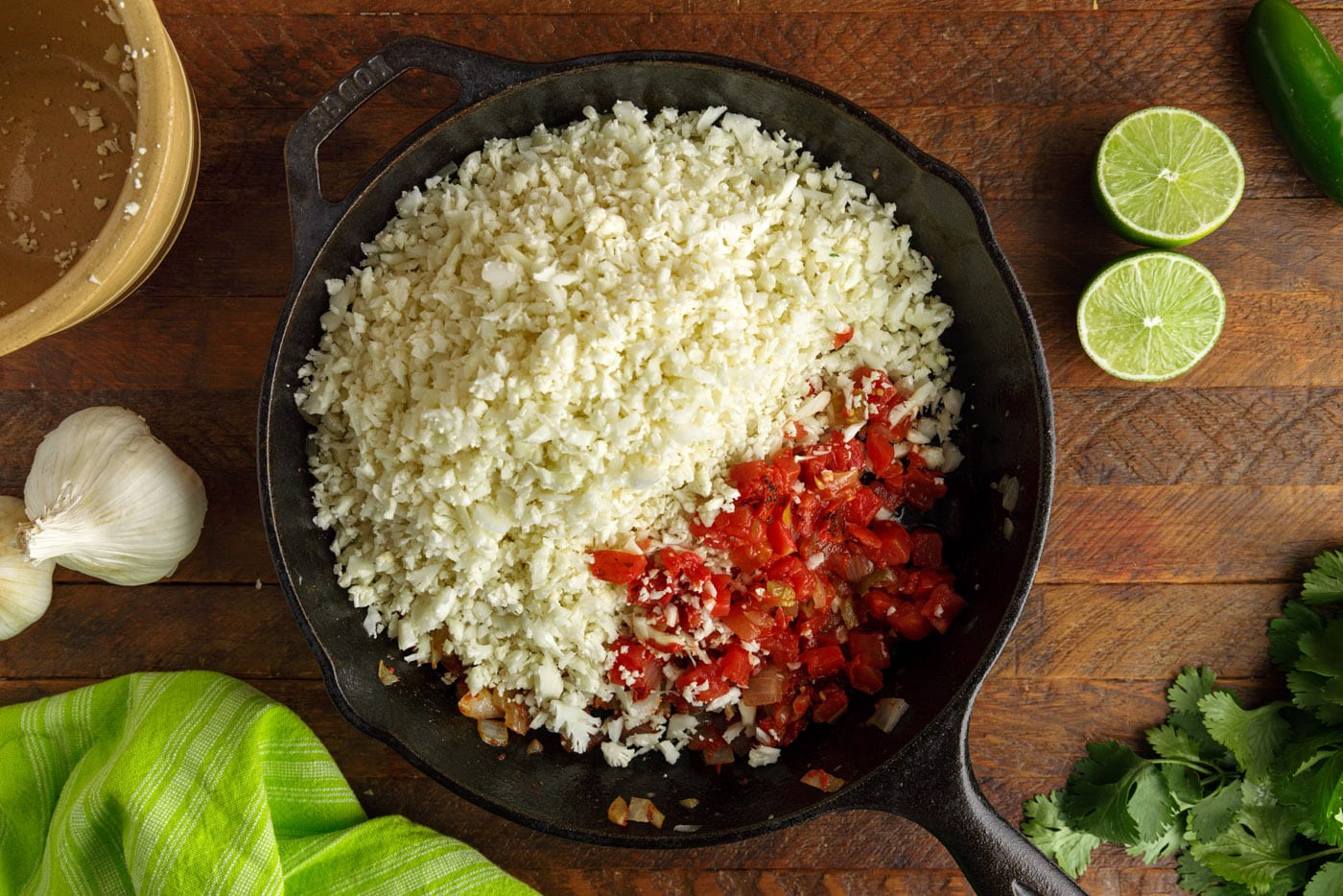 tomatoes and cauliflower rice in a skillet
