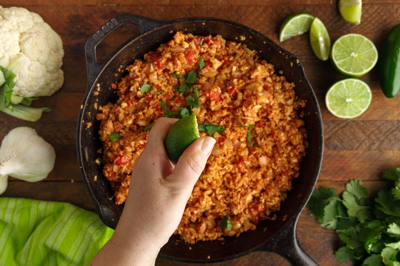 squeezing lime over mexican cauliflower rice