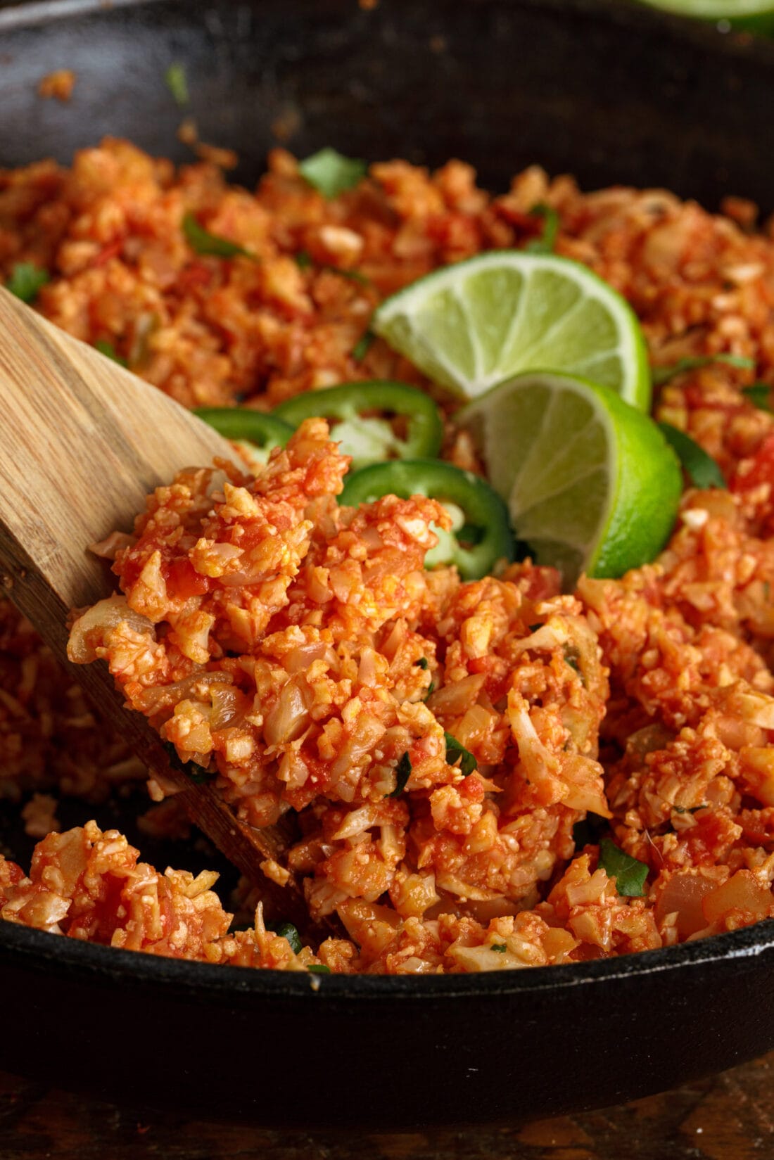 wooden spoon lifting Mexican Cauliflower Rice