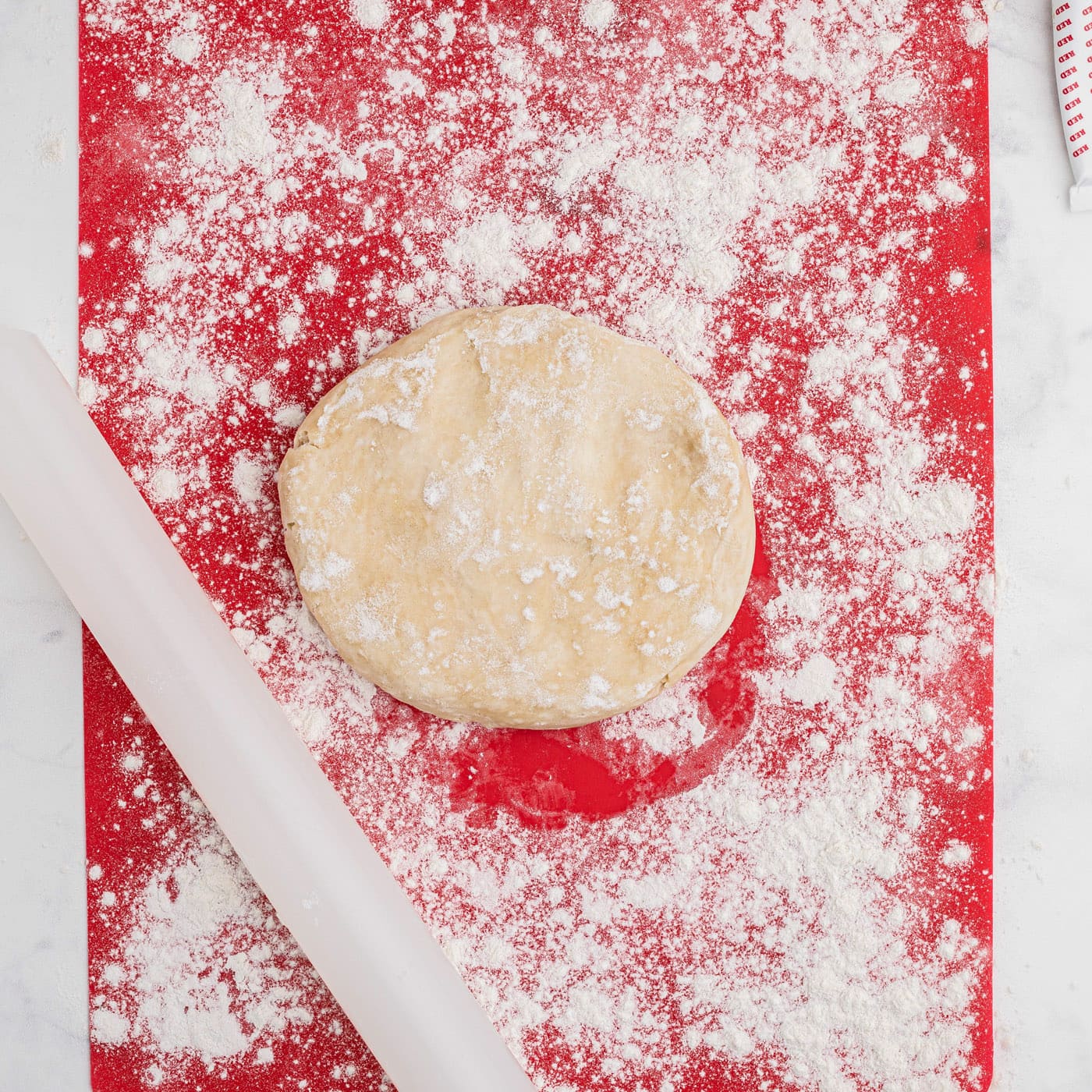 rolling out pie dough with flour