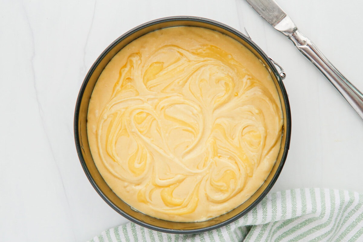 swirled lemon curd on top of cake batter
