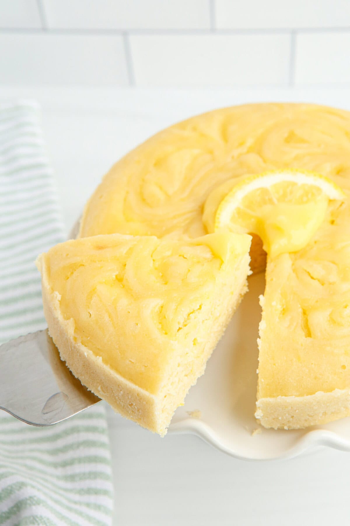 removing a slice of Instant Pot Lemon Cake
