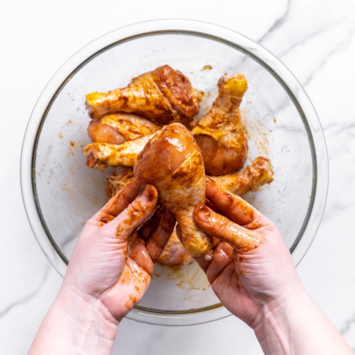 chicken drumsticks with seasonings in a bowl