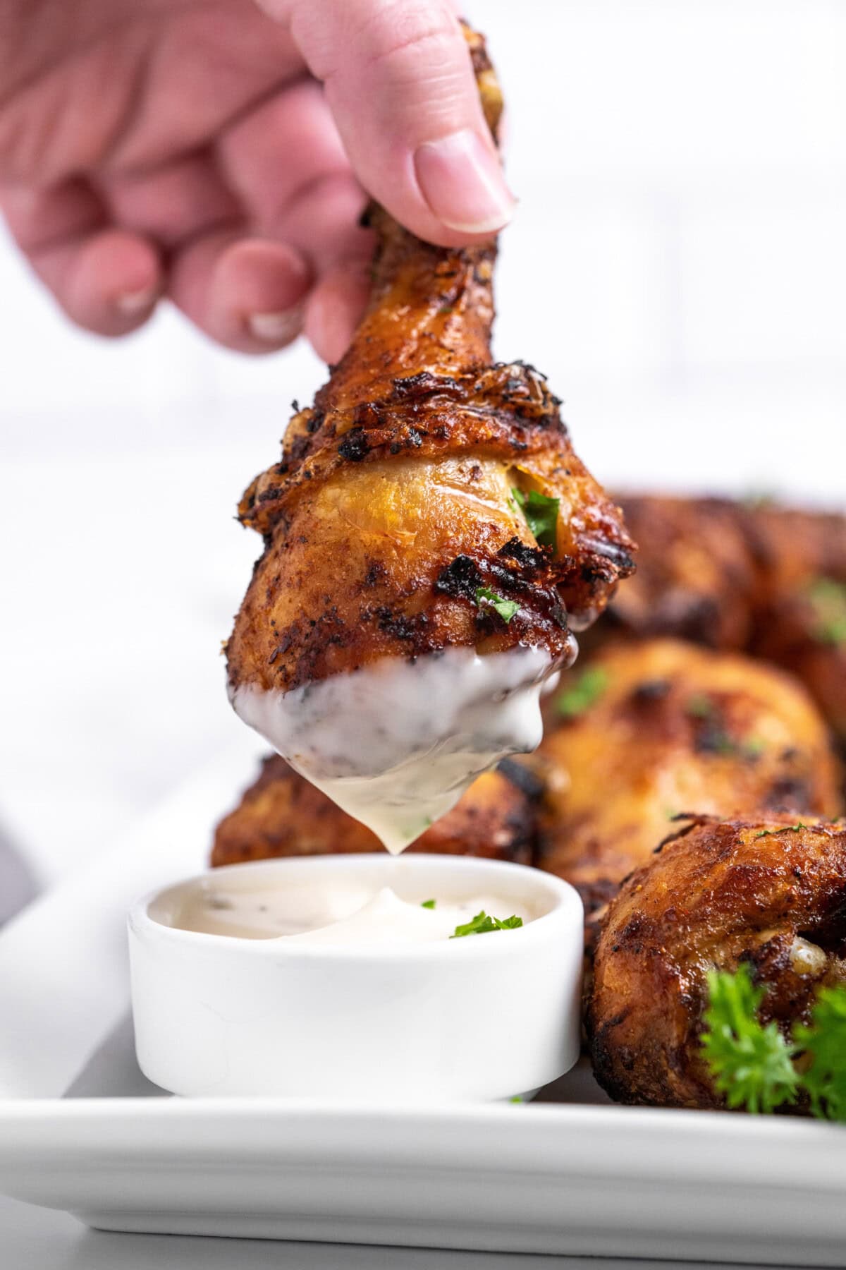 dipping a chicken drumstick into ranch