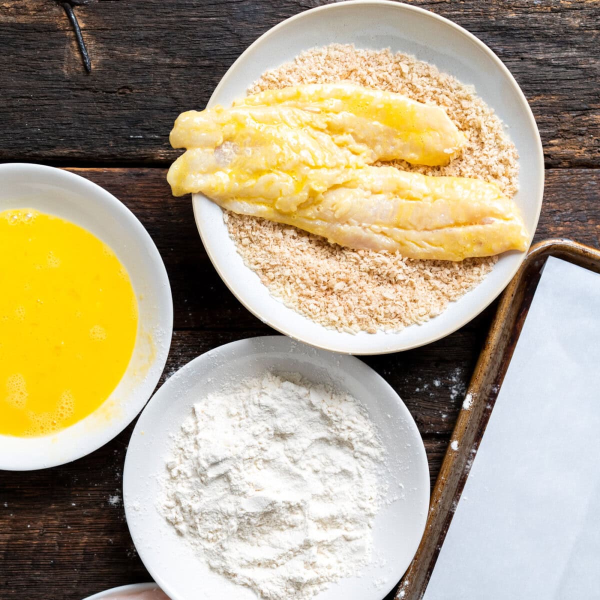 dipping cod fillets into panko breadcrumbs