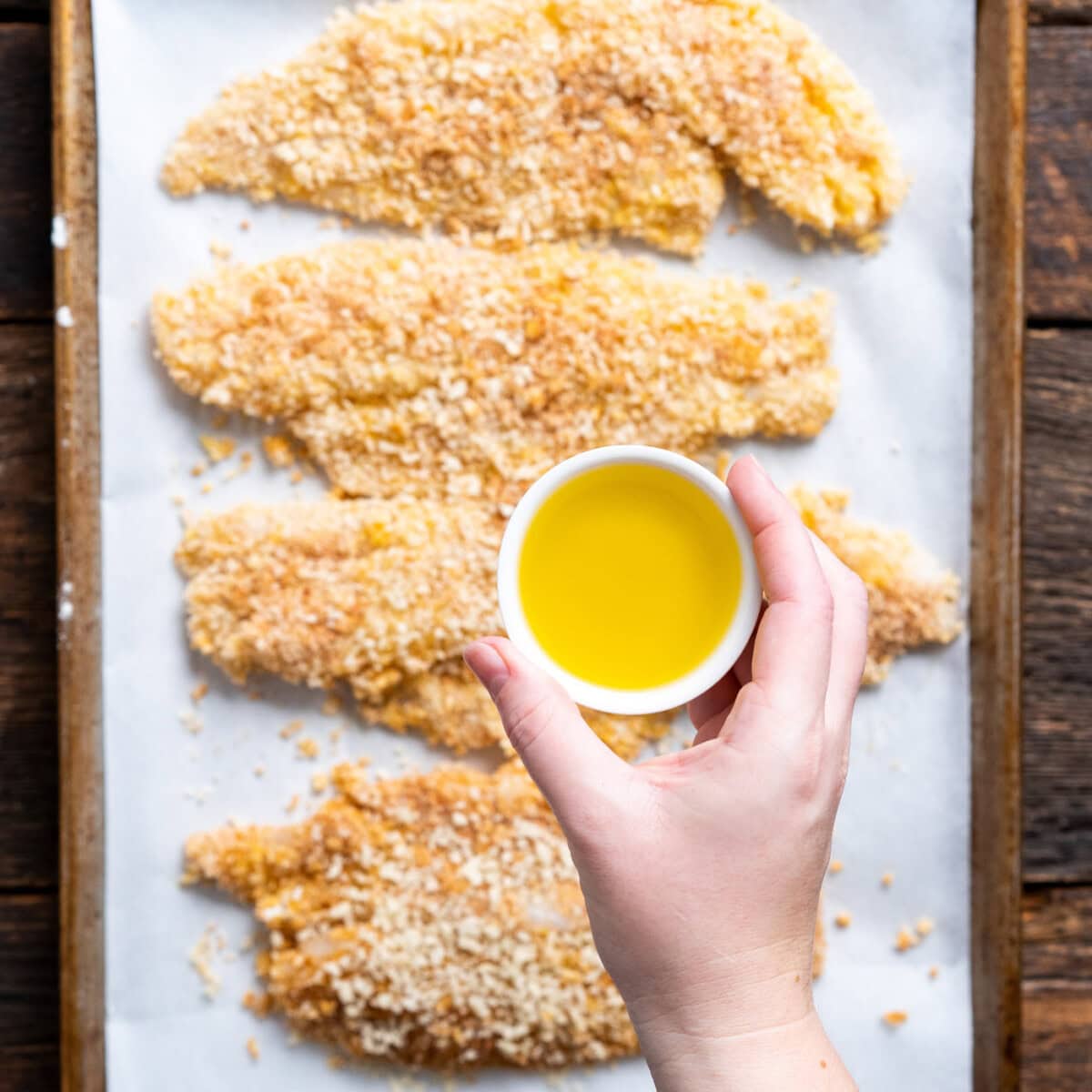 drizzling olive oil over fish fillets
