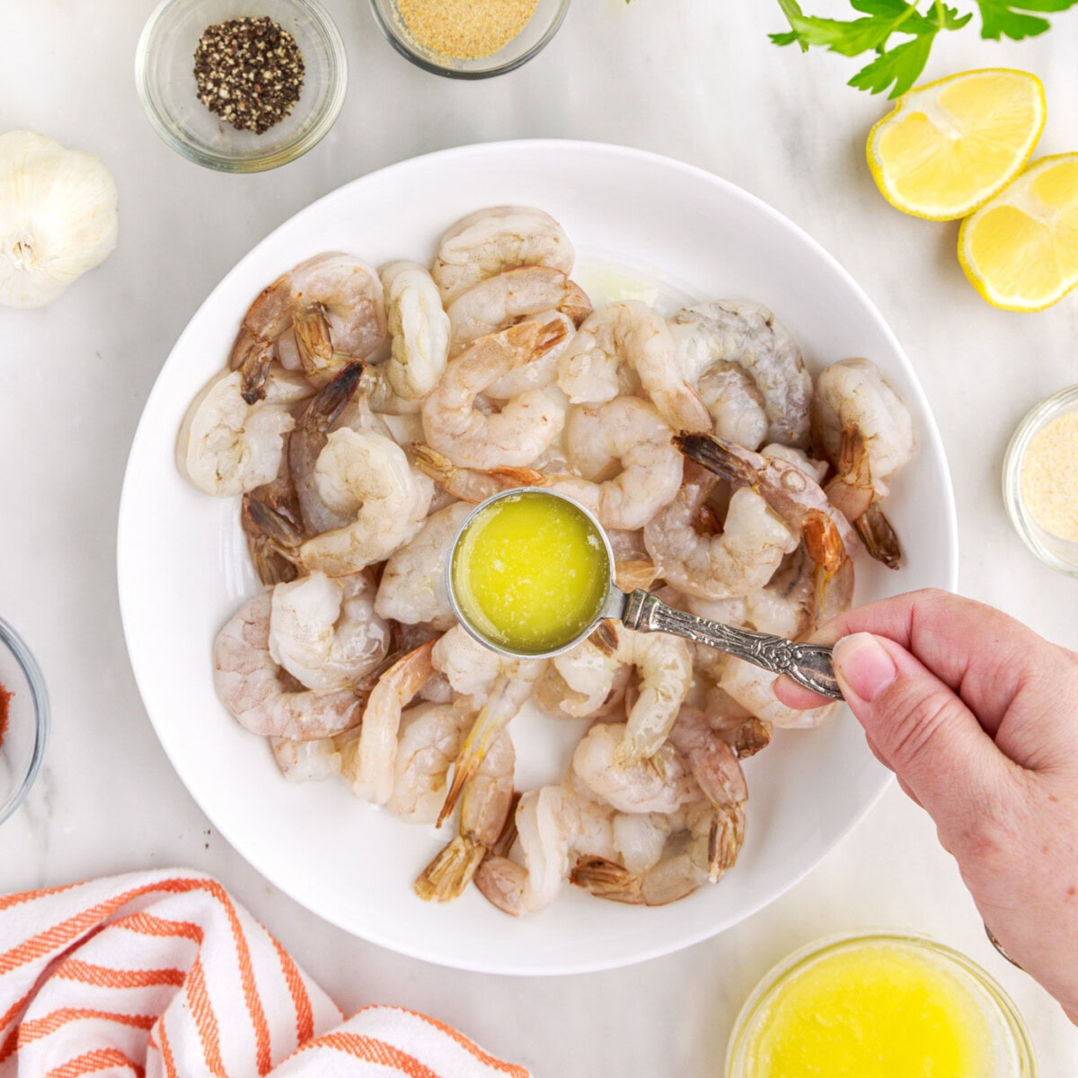 pouring melted butter over shrimp