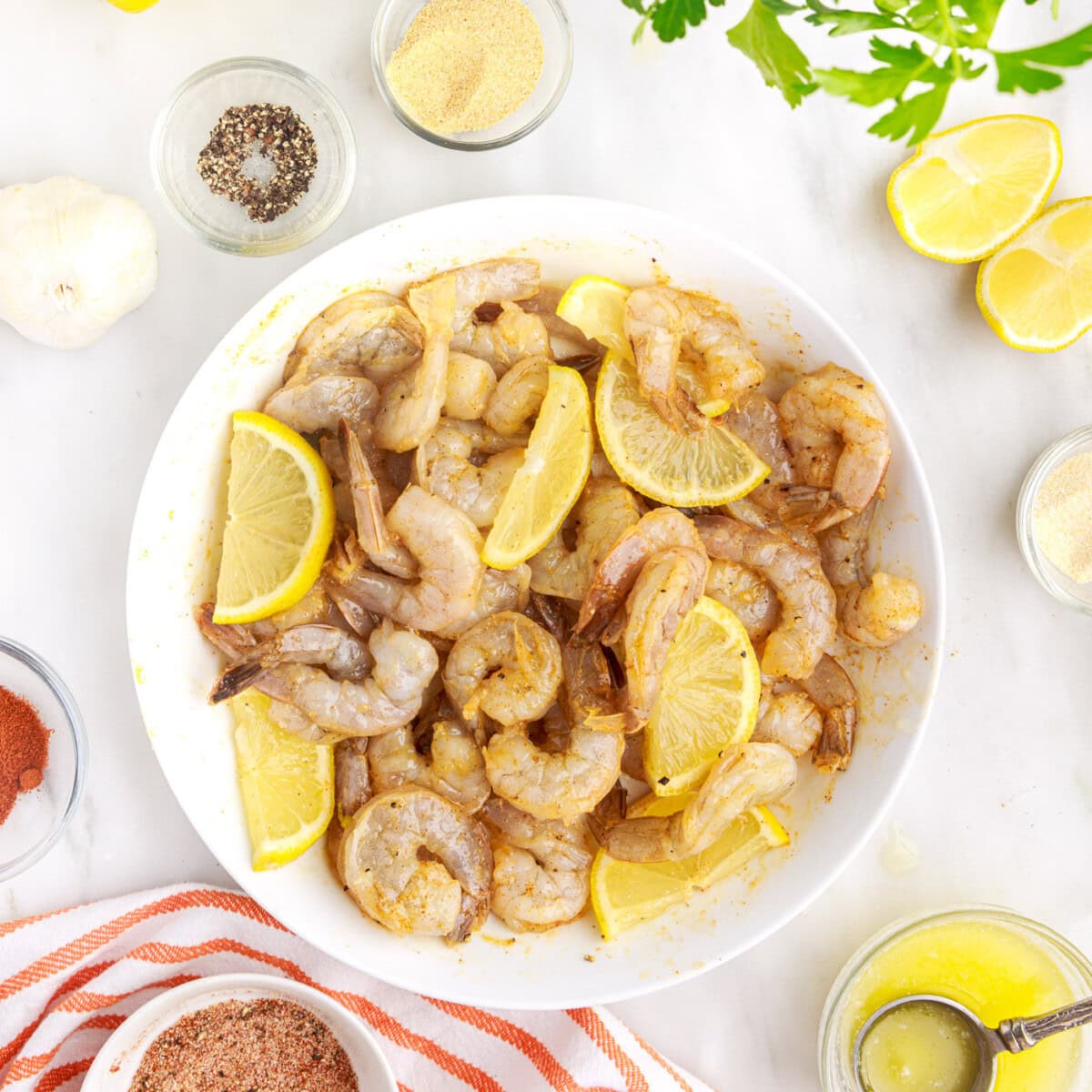 lemon wedges mixed into raw shrimp