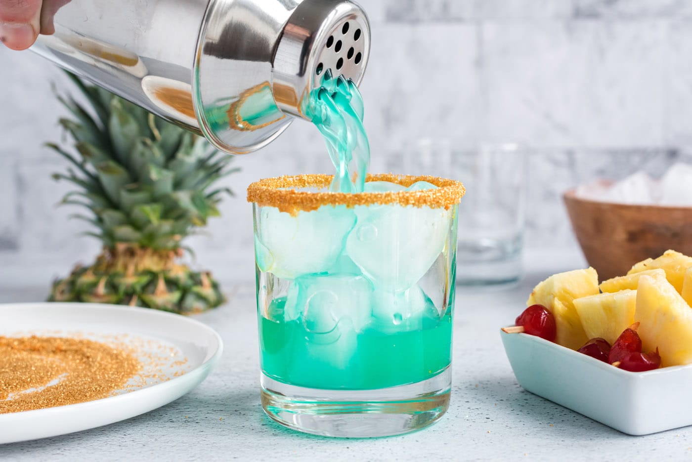 pouring boozy leprechaun drink into a rock glass