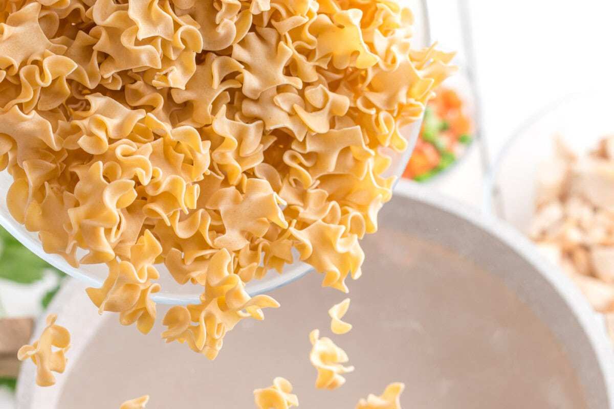 egg noodles poured into water