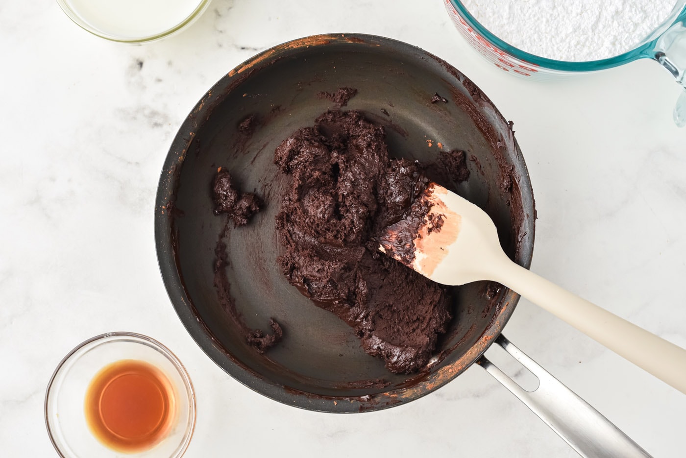 thick chocolate frosting in a saucepan