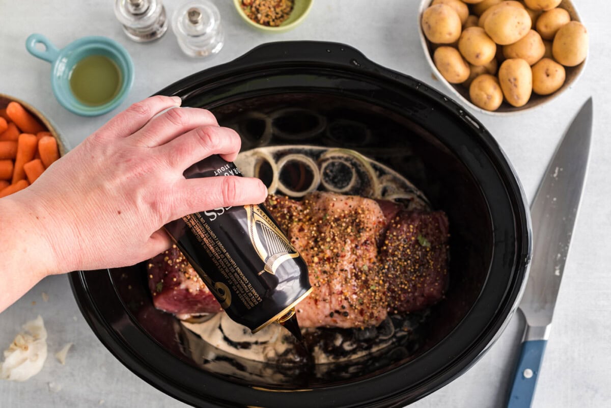 [ouring beer over crockpot corned beef