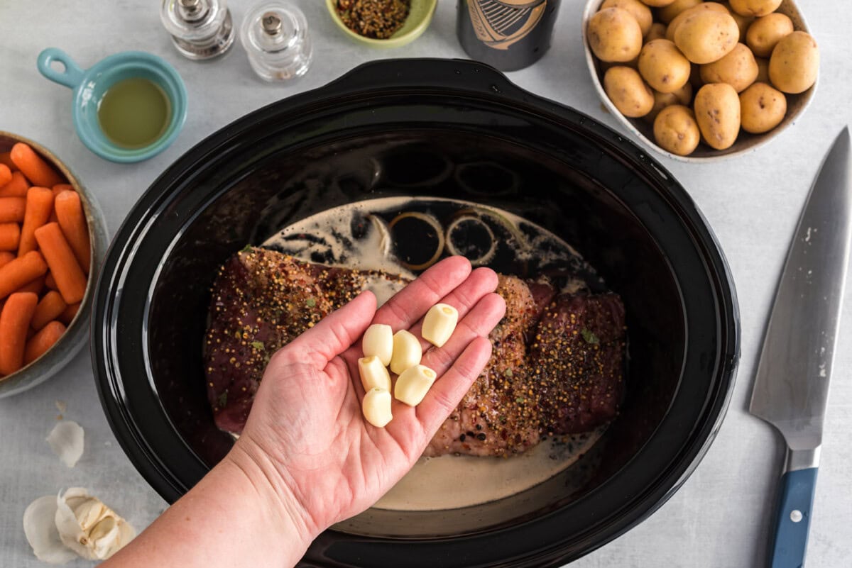garlic cloves over crockpot corned beef