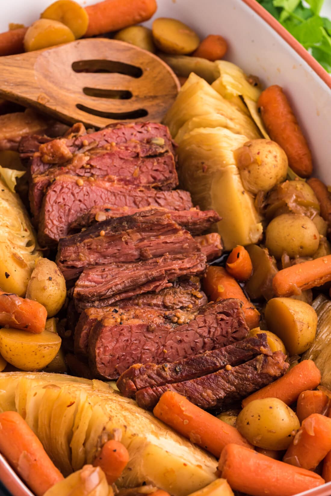 Crockpot Corned Beef with a wooden spoon