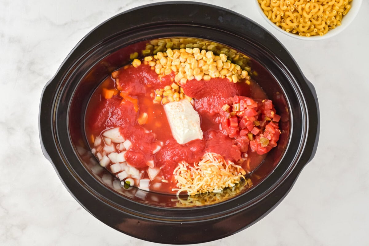 tomato sauce, cream cheese, and veggies in a crockpot