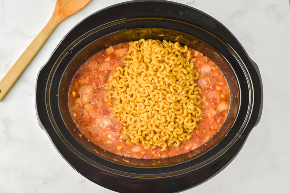 pasta on top of ground beef casserole in a slow cooker